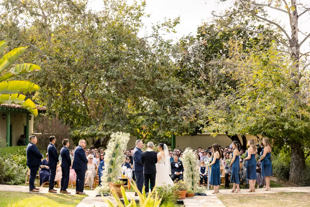 Outdoor wedding ceremony with guests seated