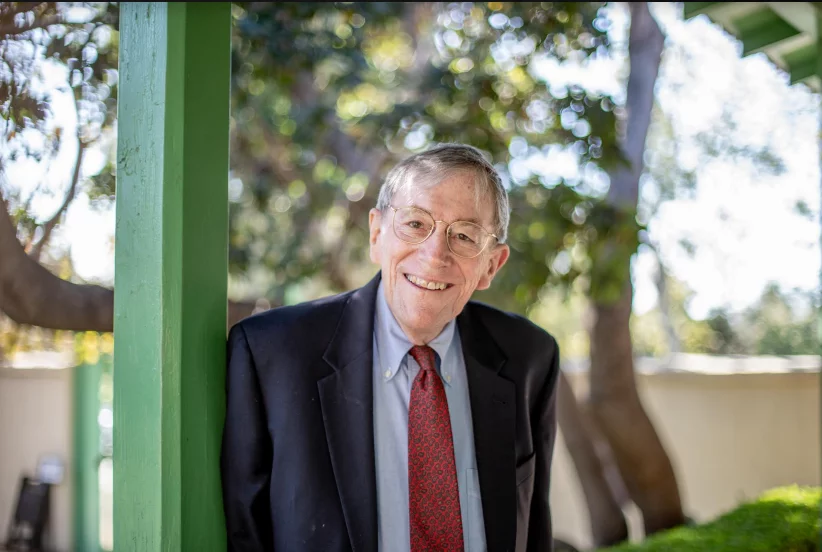 Smiling elderly man in a suit outdoors